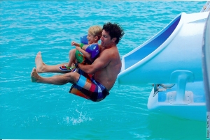 That's me with my dad on our vacation.  The slide was on the big boat and went right into the ocean!!
